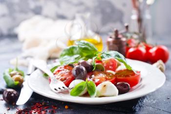 caprese salad on plate and on a table