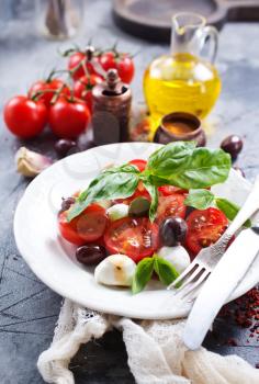 caprese salad on plate and on a table