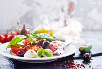 caprese salad on plate and on a table