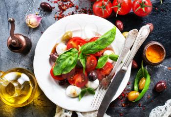 caprese salad on plate and on a table