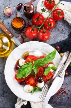 caprese salad on plate and on a table