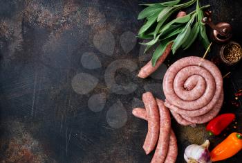 raw sausages with spice on a table