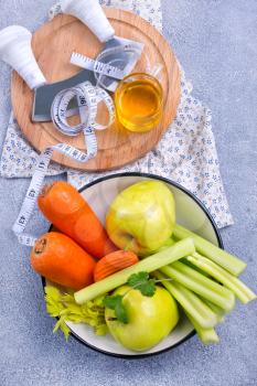 ingredients for diet salad, apples and celery and fresh carrots