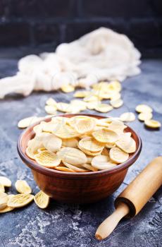 raw pasta in bowl and on a table