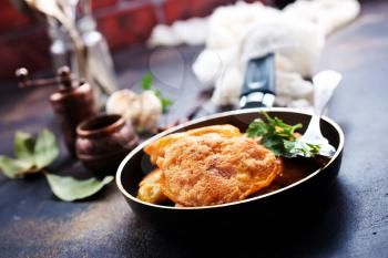 chicken cutlets in pan, cutlets with fresh greens and spice