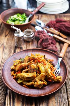 fried vegetables with meat, stew on plate