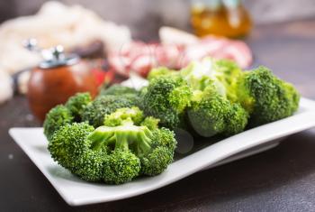 raw meat and fresh broccoli on a table