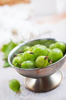 gooseberry in metal bowl, fresh gooseberry on a table