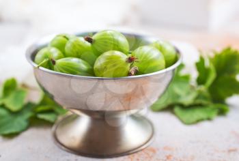 gooseberry in metal bowl, fresh gooseberry on a table