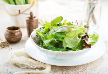 fresh salad in bowl and on a table