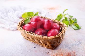fresh plums on a table, stock photo
