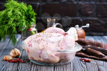 raw chicken with salt and spice on a table