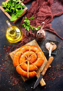 sausages on wooden board and on a table