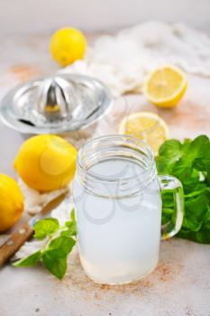 lemon juice in glass and on a table