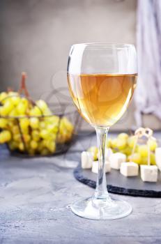 white wine and cheese on a table
