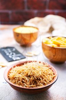 raw pasta in bowls and on a table