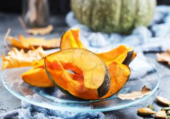 raw pumpkin on plate and on a table