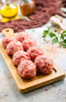 raw meatballs with aroma spice and on a table
