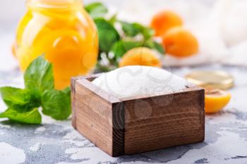 sugar and apricots on a table, ingredients for cooking jam