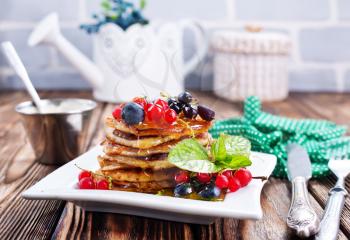 pancakes with berries and on a table