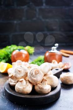 mushrooms on wooden plate and on a table