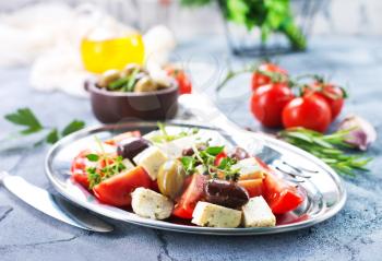 greek salad on plate and on a table