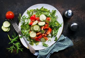 fresh salad with vegetables and oil on the plate