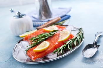raw salmon with lemon on a table