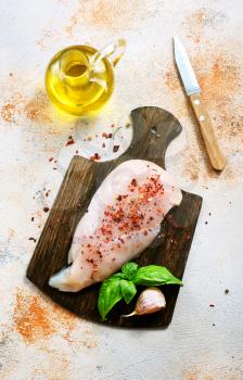 raw chicken fillet on the wooden board