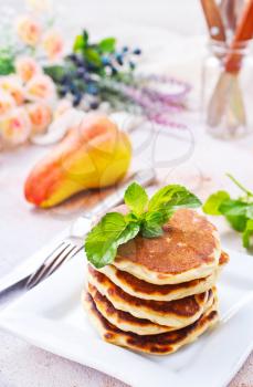 pancakes on plate and on a table