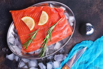 raw salmon with salt and lemon on a table