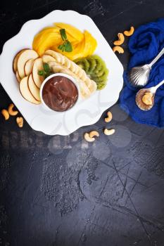 fresh salad of fruits, salad with fruits and chocolate sauce, stock photo