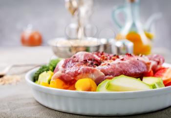 raw meat with vegetables on plate, ingredients for dinner