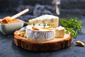Various types of cheese, blue cheese and brie with honey and nuts