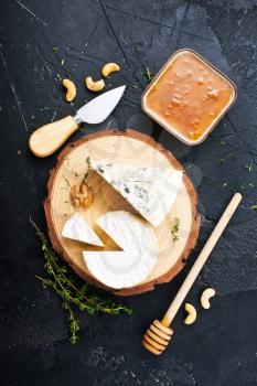 Various types of cheese, blue cheese and brie with honey and nuts