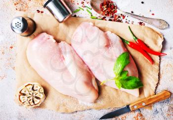 raw chicken fillet with spice and salt. chicken fillet on board, stock photo