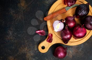 raw onions on wooden board, stock photo
