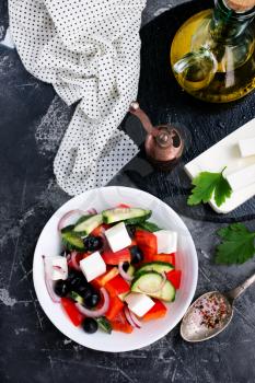 greek salad in white bowl, vegetables and feta