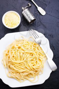 Spaghetti or pasta is homemade Italian traditional food. Cooked pasta on table.
