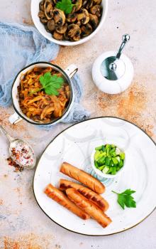 sausage with cabbage on the plate, fried sausages