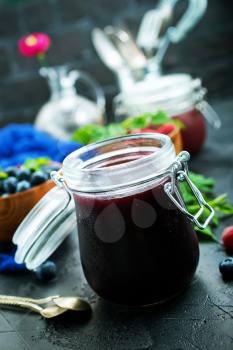 homemade jam in bank and fresh berries