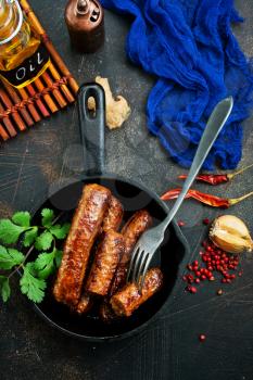 fried sausages in pan, sausages for dinner