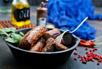 fried sausages in pan, sausages for dinner