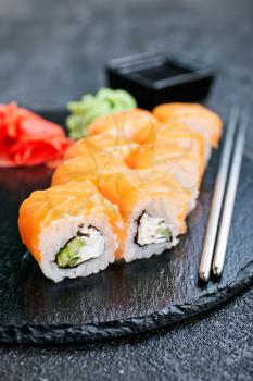 Sushi with chopsticks. Sushi roll japanese food on a table