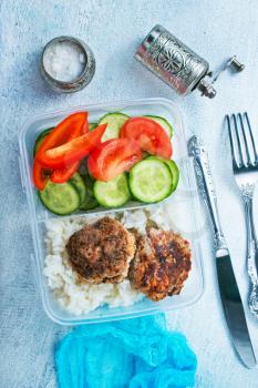 rice with cutlets and vegetables in lunchbox
