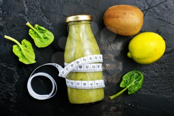 smoothie with spinach and kiwi in bottle