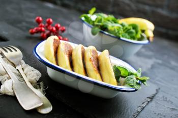 cottage cheese pancakes syrniki on plate, cheese pancakes and mint leaves