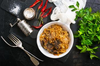 fried cabbage with mushrooms in white bowl