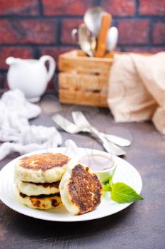 Traditional russian breakfast fried cottage cheese. Top view cheese pancake, close up.