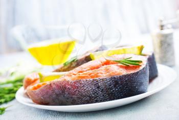 raw salmon steak with spice and oil 
